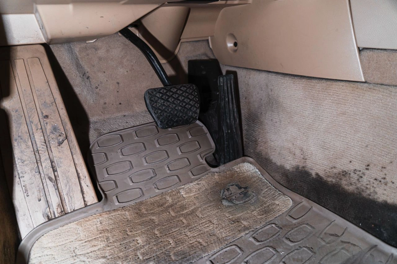 BMW 5 E60 — грязный коврик и нижняя обивка водительского пространства крупным планом